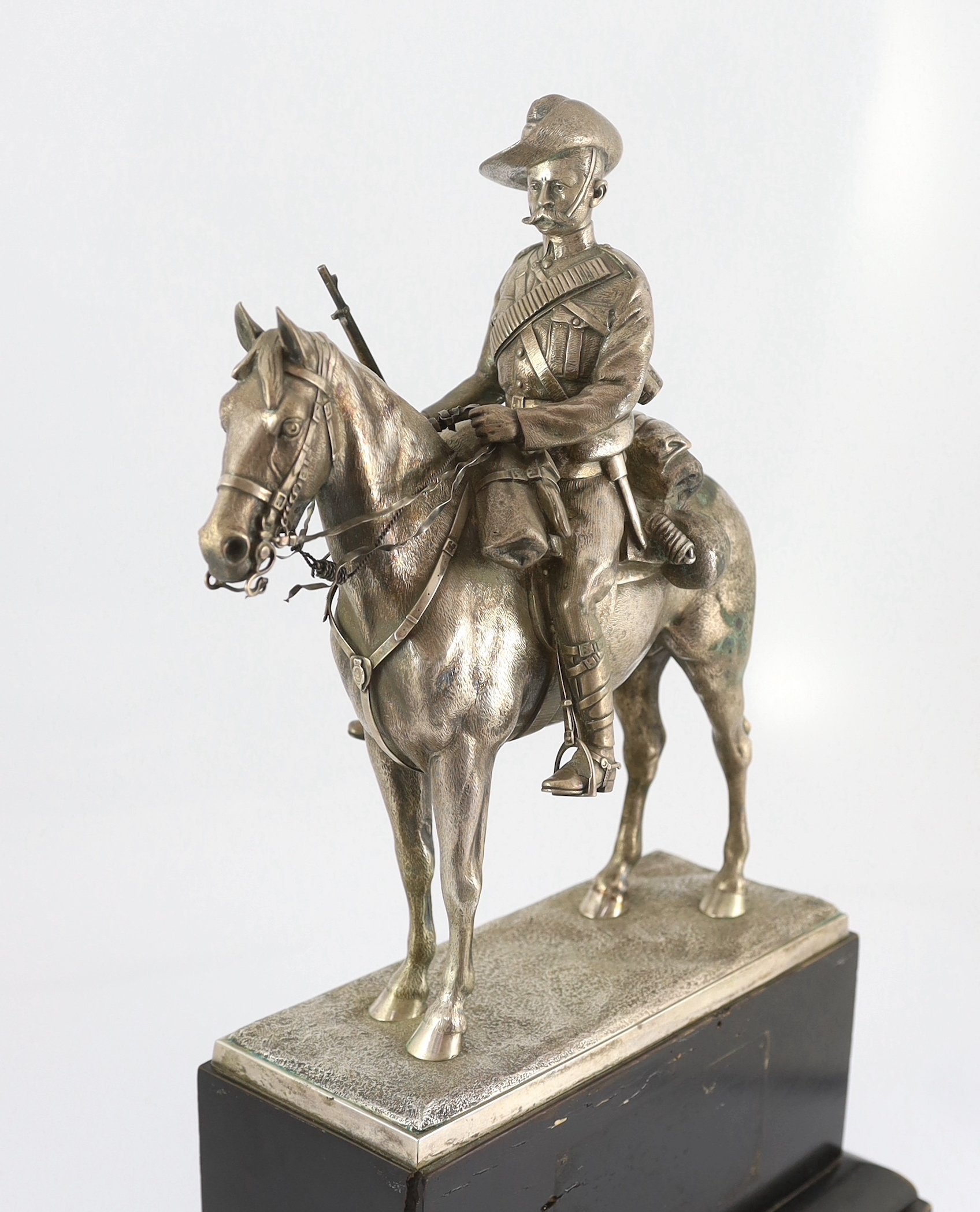 An early 20th century silver model of a City Imperial Volunteer, holding a rifle, on horseback, early 20th century